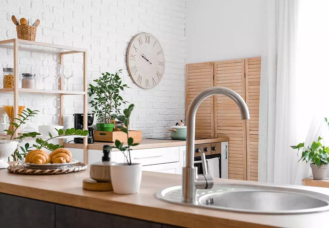 Bright Kitchen featuring Large Clock on a White, Brick Wall