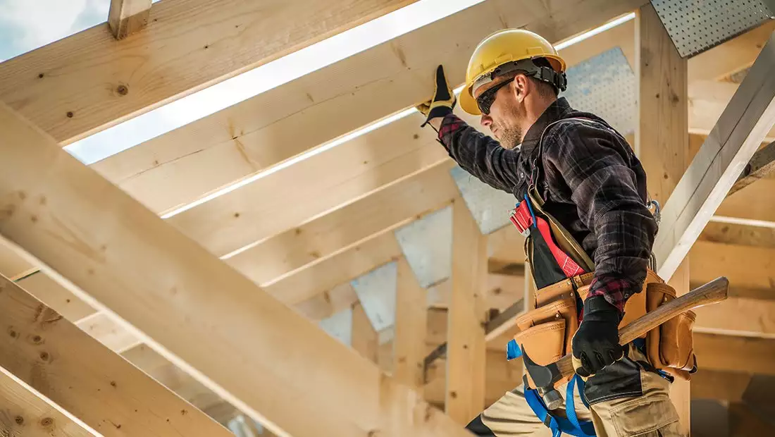 Construction Worker Installing a Roof Truss