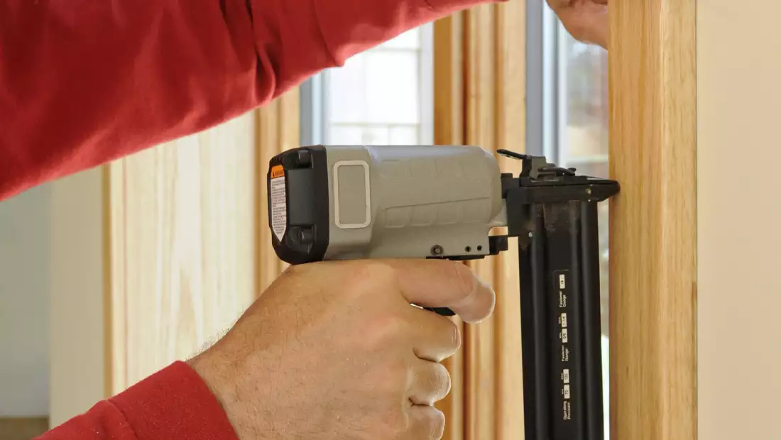 Nail Gun Being Used on a Window Frame