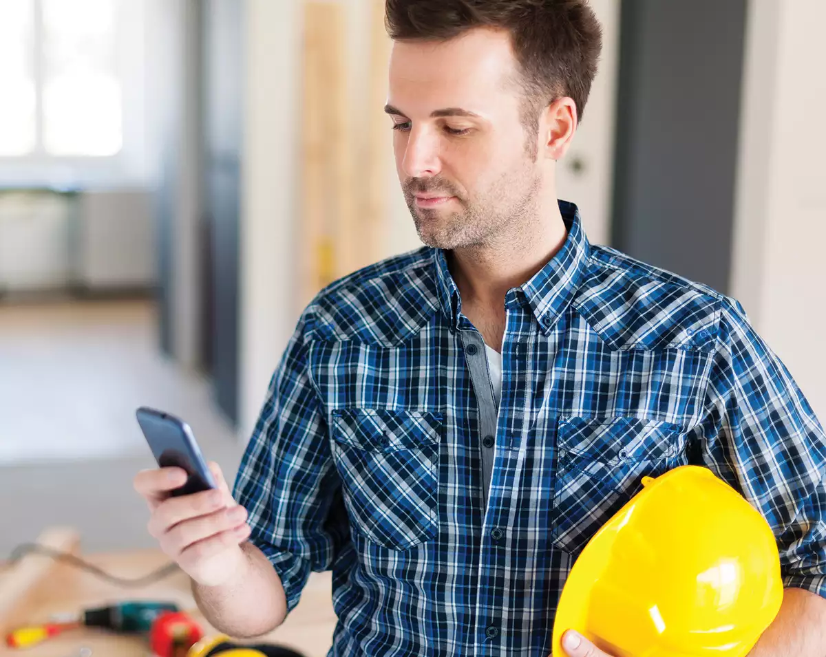 Construction Worker Looking at Phone